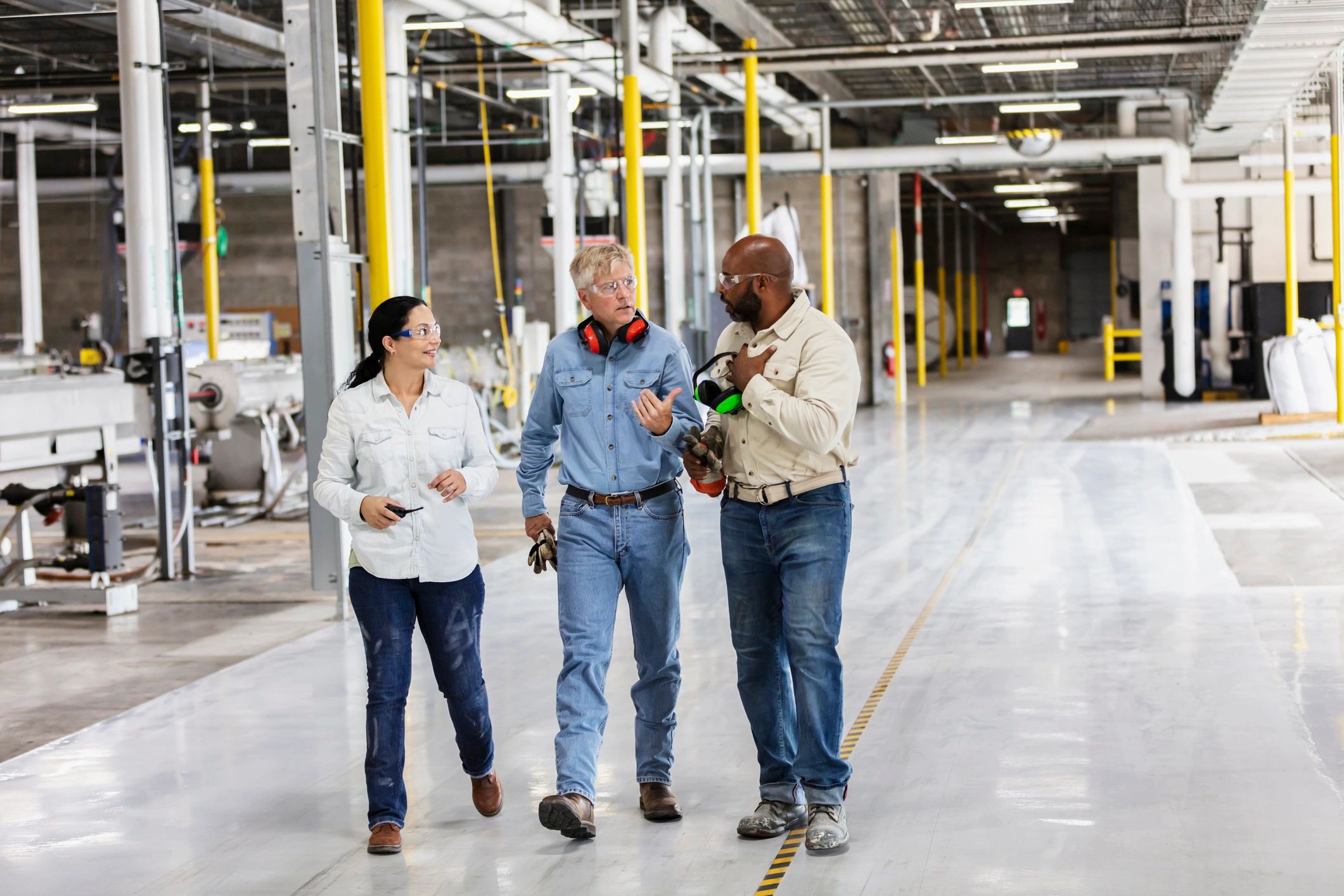 Industrial workforce walking and talking on a factory floor