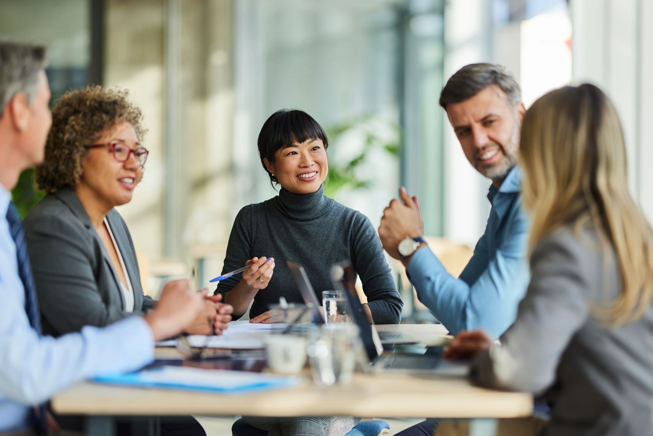 Business support staff collaborating during an office meeting