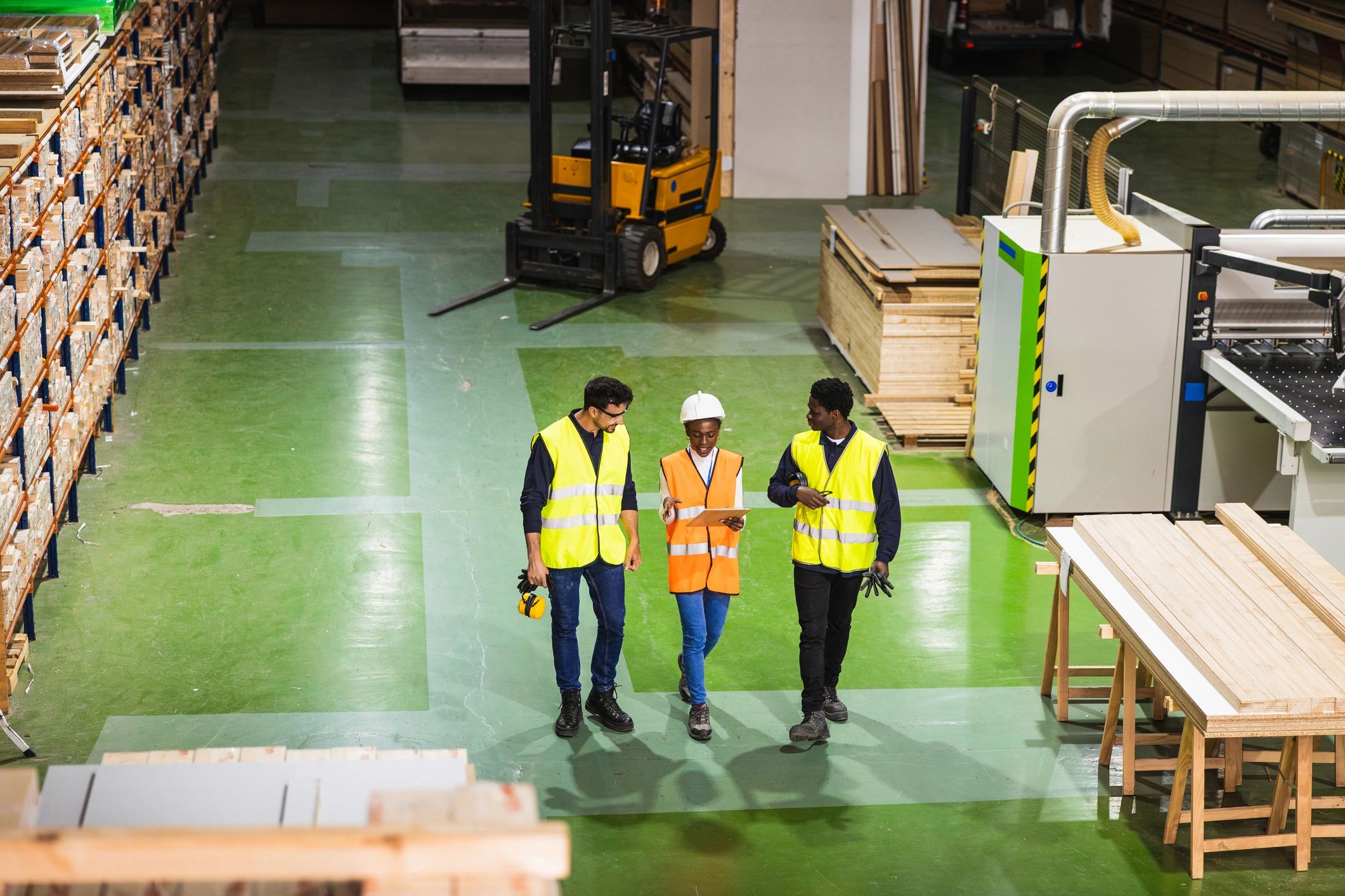 Industrial team discussing plans in a warehouse