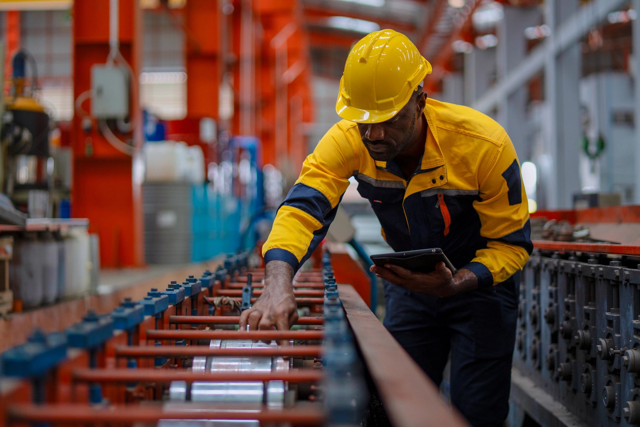 Factory worker operating in a metal sheet facility
