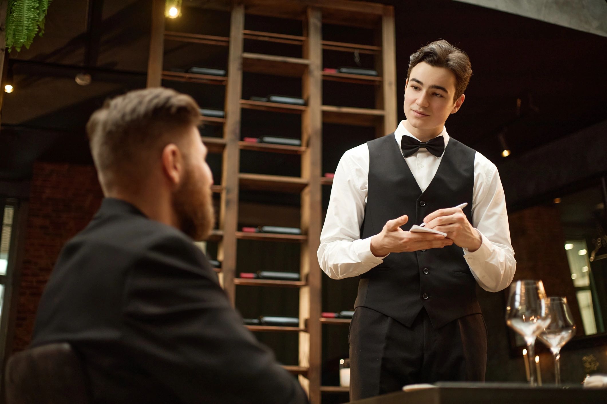 Waiter taking an order from a restaurant guest
